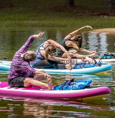 group of people doing SUP yoga on paddleboards in Lake Allatoona