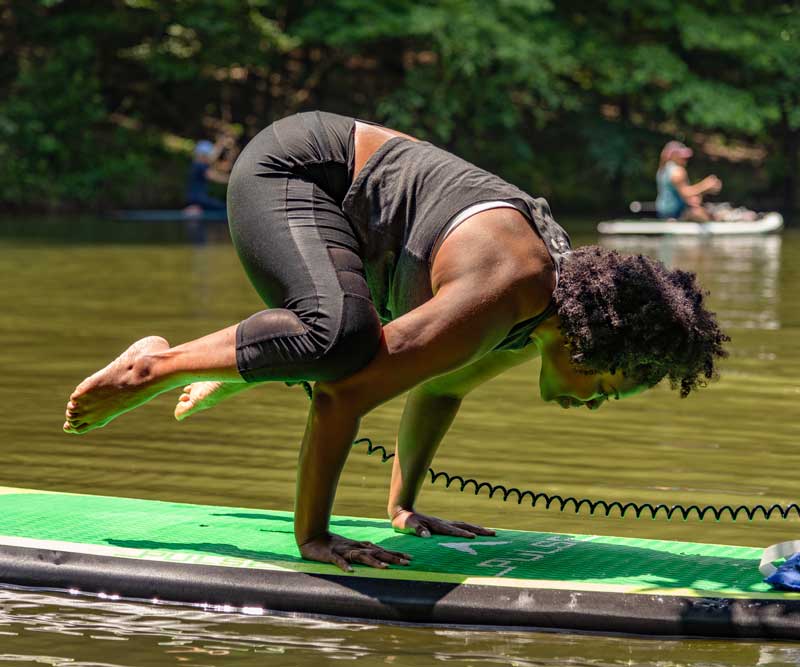 woman on Lake Allatoona doing SUP Yoga