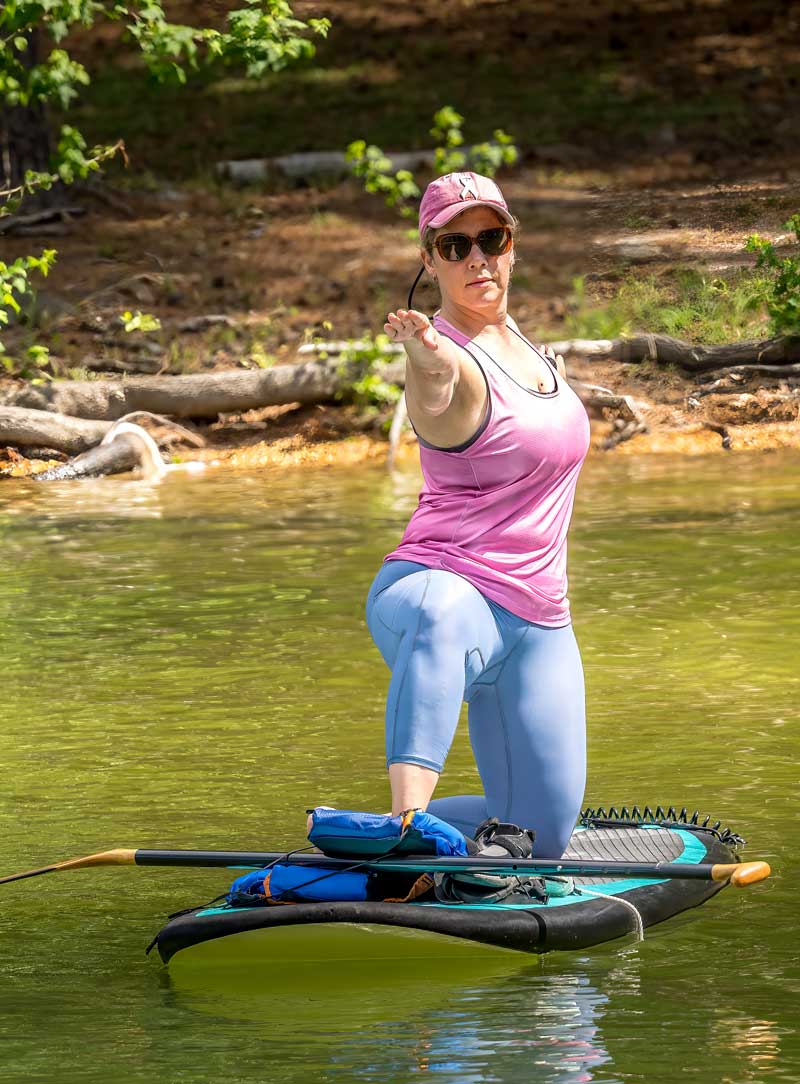 woman doing SUP yoga in North Georgia on paddleboard and water
