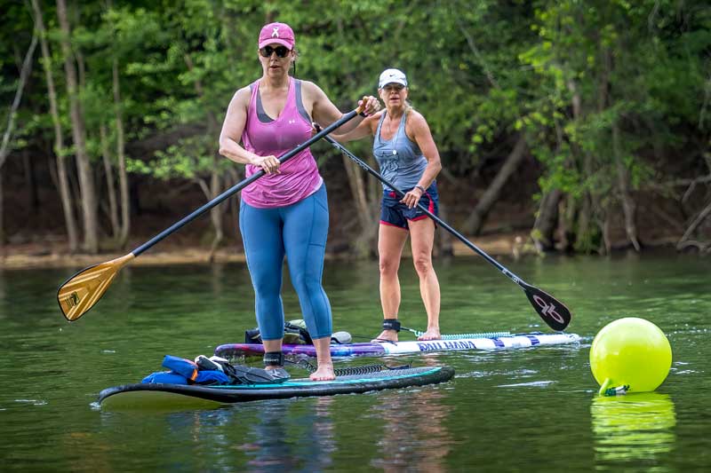 two women doing SUP PaddleFit on Lake Altoona 