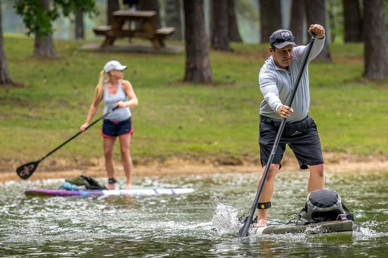 man teaching stand up paddleboarding