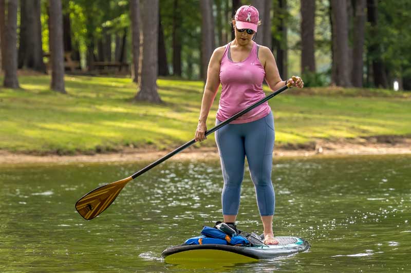 woman learning stand up paddleboarding